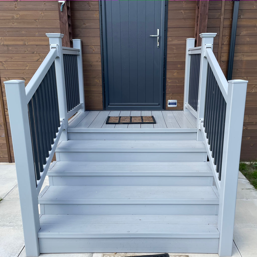 An example of a fully installed set of four tread box steps with an entry platform in the light grey colour