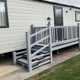 An example of a fully installed 6' x 3' 10" entry platform with steps and a gate in the light grey colour